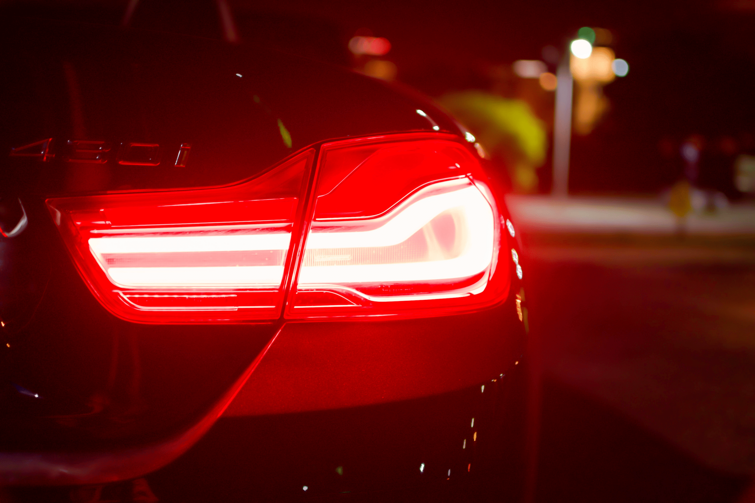 A car with a hood open, showing the process of regular inspection of car lighting