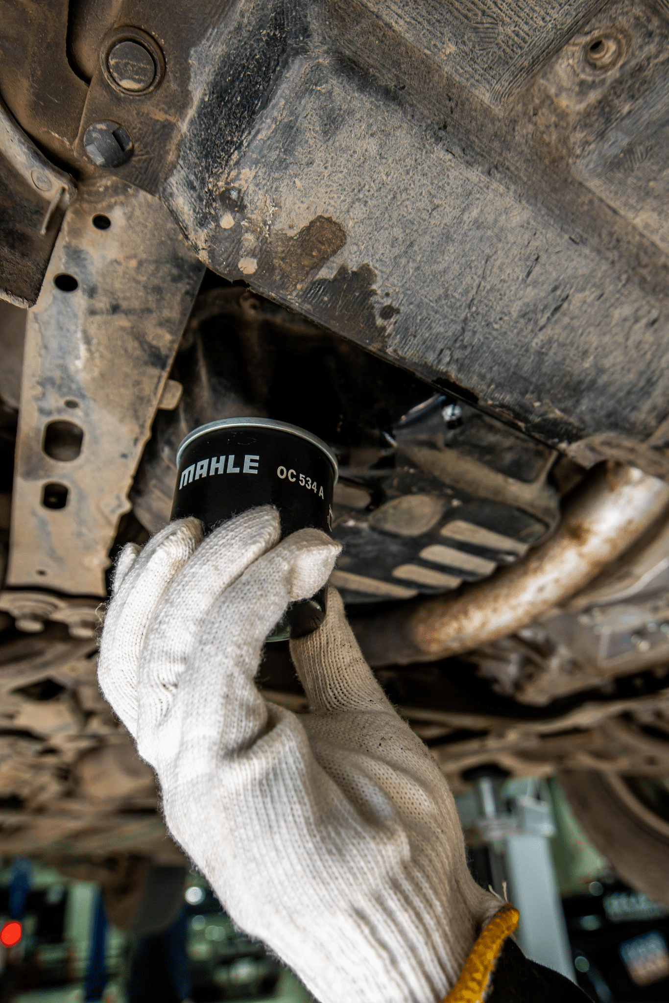A mechanic replacing a car part