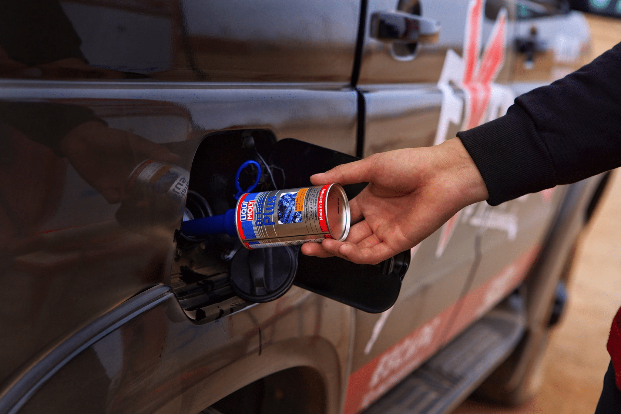 A car engine with octane booster fuel additives to improve fuel system and engine performance