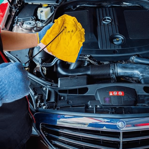 A car with the engine oil being checked